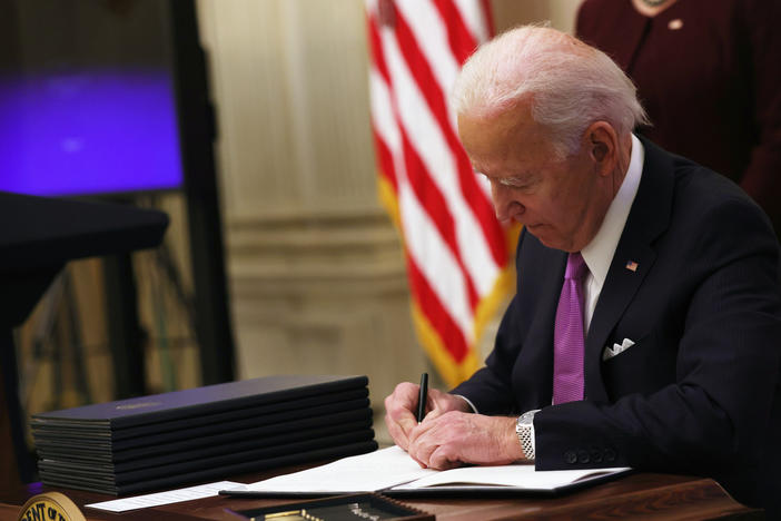 President Biden signs an executive order Thursday at the White House.
