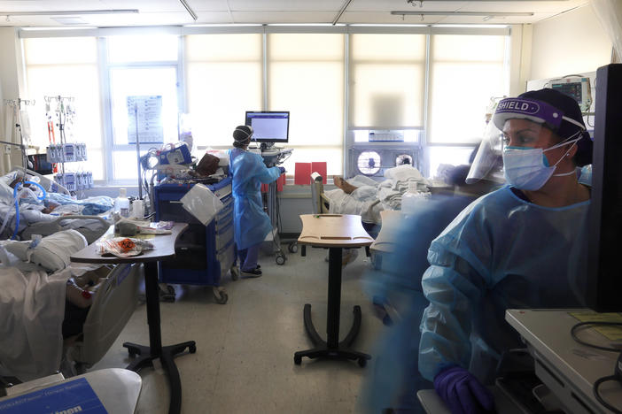 Clinicians care for COVID-19 patients last week in a makeshift intensive care unit at Harbor-UCLA Medical Center in Torrance, Calif. California is lifting regional stay-at-home orders, but county and local authorities can keep other restrictions in place.