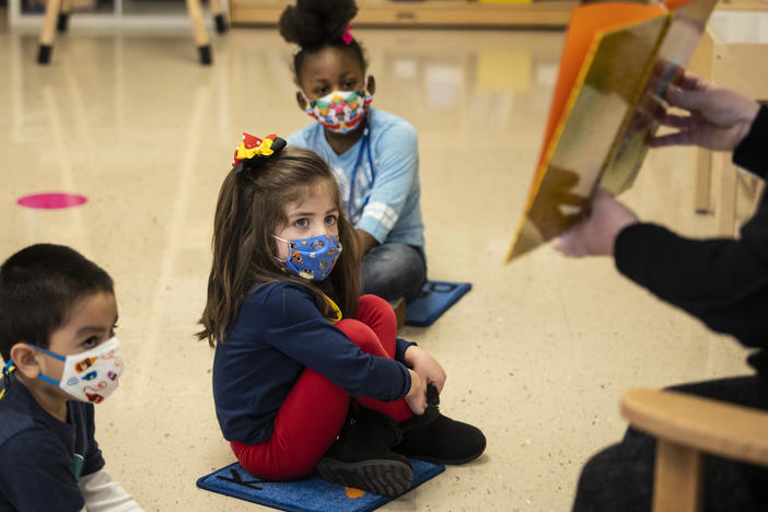 Prekindergarten students listen as their teacher reads a story this month at Dawes Elementary School in Chicago.