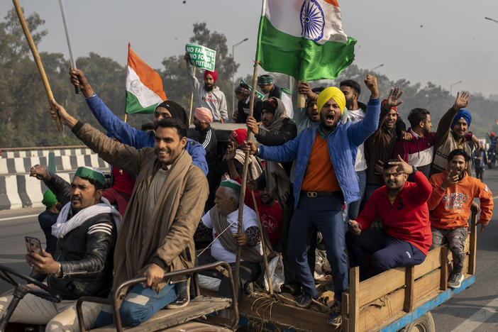 Protesting farmers riding tractors shout slogans as they march to the capital during India's Republic Day celebrations on Tuesday in New Delhi.
