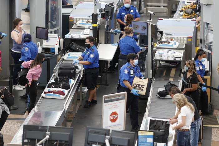 TSA agents clearing passengers at Denver International Airport, June 2020. TSA found twice as many weapons on passengers per million in 2020 than they did the year prior.