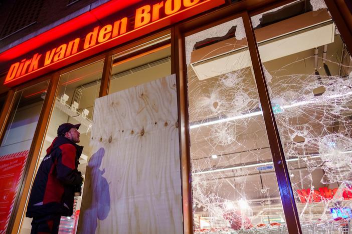 Protesters threw fireworks and rocks at police, damaged storefronts and looted stores during demonstrations on Monday in the Netherlands.