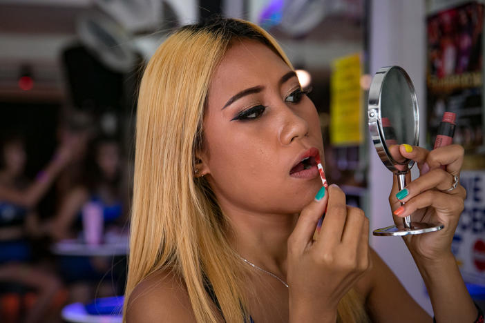 Above: N., a sex worker at a bar in Pattaya, Thailand. The sex trade has offered good-paying jobs for many people from rural areas who were facing a life of tending rice paddies and digging up cassava roots.