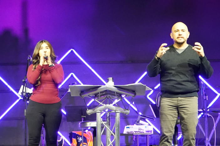 Angel Flores (right), founder and lead pastor of Mosaic Church, delivers the message during the Spanish worship service.