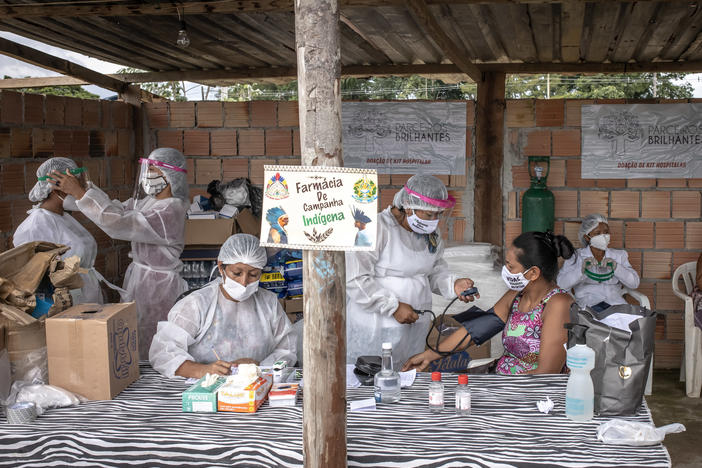 Indigenous health care workers treat patients last week at a campaign hospital set up in the Parque das Tribos neighborhood of Manaus, Brazil. Oxygen shortages at hospitals in Brazil's Amazon prompted authorities to airlift patients to other states.
