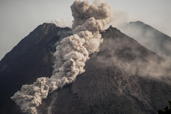 Mount Merapi, Indonesia's most active volcano, spews rocks and gas into Wednesday's morning sky.