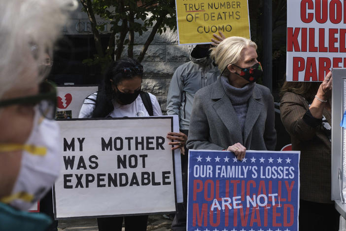 Families of COVID-19 victims who died in New York nursing homes gather in front of the Cobble Hill Heath Center in the Brooklyn borough of New York City in October. A report issued Thursday by New York's state attorney general says health officials undercounted nursing home deaths by as much as 50%.