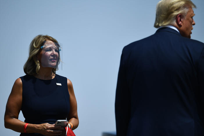 Then-President Donald Trump is greeted by Kelli Ward, chair of the Arizona Republican Party, during a stop in Arizona last year.