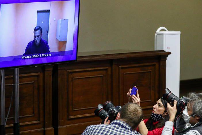 Journalists watch Alexei Navalny appear on a video screen in a Moscow regional court. The court rejected Navalny's appeal of his 30-day detention.
