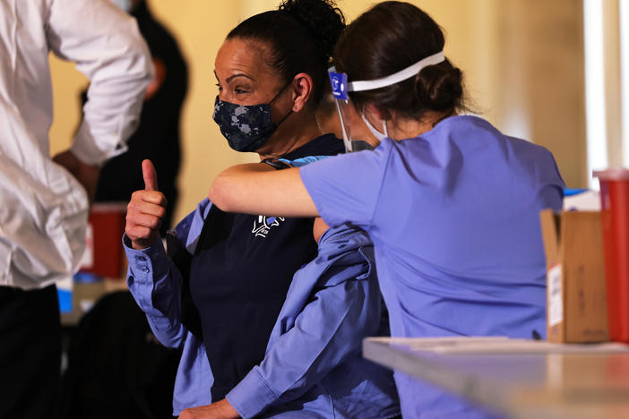 A member of FDNY EMS gives a thumbs up while receiving Moderna's vaccine against the coronavirus in late December. By mid-January, New York City Medical Reserve Corps volunteers also were mobilized to help with the vaccine effort.