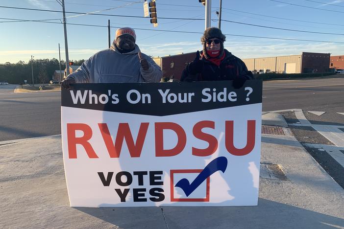 Representatives from the Retail, Wholesale and Department Store Union hold a pro-unionization sign outside Amazon's warehouse in Bessemer, Ala.