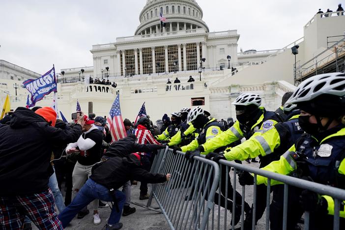 In this Wednesday, Jan. 6, 2021 file photo, Trump supporters try to break through a police barrier at the Capitol in Washington, D.C.