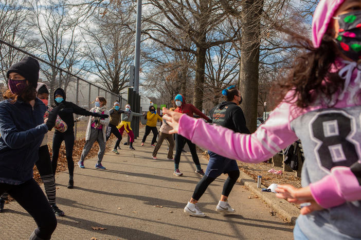 Michael Aredes teaches a Zumba class outside Prospect Park in  Brooklyn. About 10 women bundled up to join the socially distant exercise class on a recent Saturday.