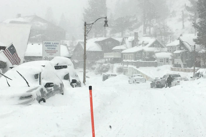 In this photo provided by Caltrans District 9, heavy snowfall blankets cars at June Lake, in Mono County, Calif., on Wednesday. The same storm that brought snow and heavy rain to the state is moving through the Midwest, with 5 to 9 inches of snowfall predicted in some regions by Sunday.