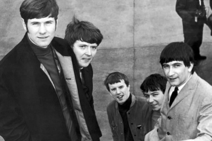 The Animals, from left, Hilton Valentine, Chas Chandler, John Steel, Eric Burdon and Dave Rowberry, board an airliner in London bound for New York on May 27, 1965, to appear on "The Ed Sullivan Show". Valentine died Friday at the age of 77.