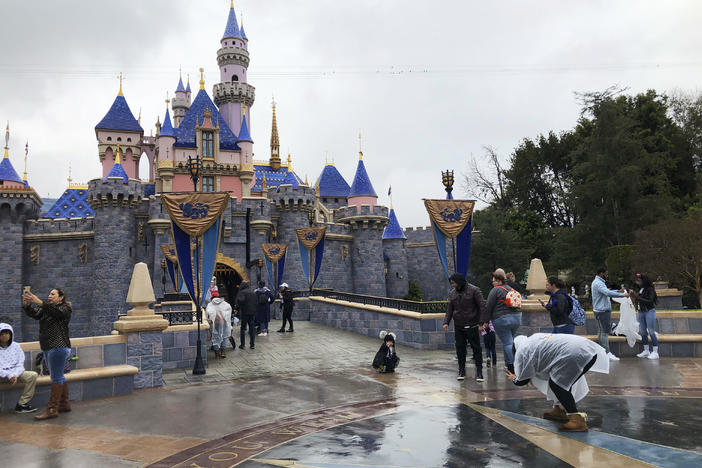 Visitors take photos at Disneyland in Anaheim, Calif., in March 2020. Jungle Cruise, one of the original Disney parks' rides, is getting a 21st century remodel by "imagineers" at the Disneyland park in California and the Magic Kingdom park in Florida with a new storyline and characters that "reflect and value the diversity of the world around us," Disney said in a blog post last week.