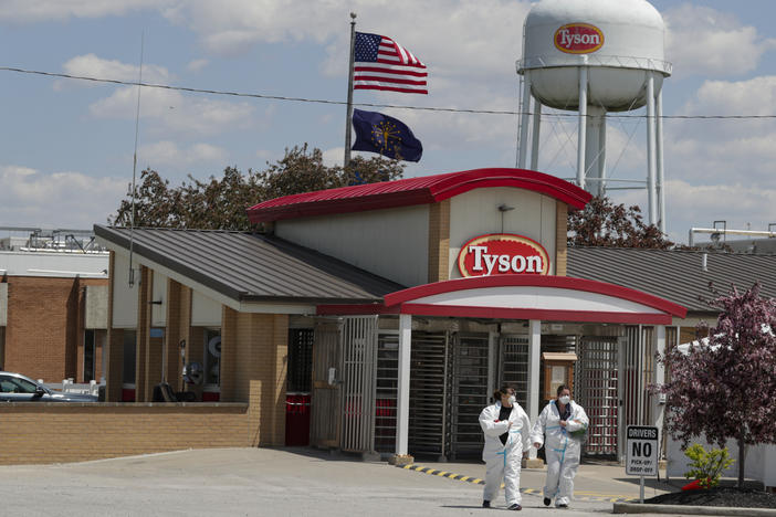 Workers are shown leaving the Tyson Foods pork processing plant in Logansport, Ind., in May. A House subcommittee is investigating the Trump administration's handling of COVID-19 outbreaks at meatpacking plants, focusing on the Occupational Safety and Health Administration as well as major companies Tyson, Smithfield and JBS.