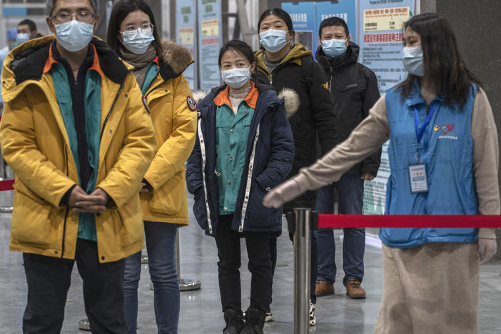 Chinese workers wait to receive a COVID-19 vaccine jab at a mass vaccination center in Beijing on Jan. 5. Even with at least 5 homegrown vaccines nearing approval, China is setting a modest initial goal: 50 million people vaccinated by mid-February — about 3.5% of the total population.