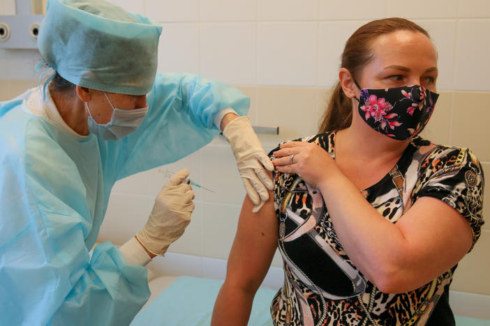 Russia's Sputnik vaccine was found to be effective in preventing COVID-19 symptoms, according to a new study published in <em>The Lancet</em> medical journal. Here, a patient gets a shot of the Russian vaccine at Sochi's City Hospital No 4.