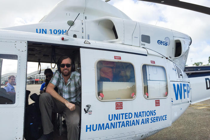 Dr. Eugene Richardson in a helicopter during the Ebola outbreak in Sierra Leone, where he worked as a clinical lead for Partner in Health's response to the outbreak. He is the author of the new book <em>Epidemic Illusions: On the Coloniality of Global Public Health.</em>