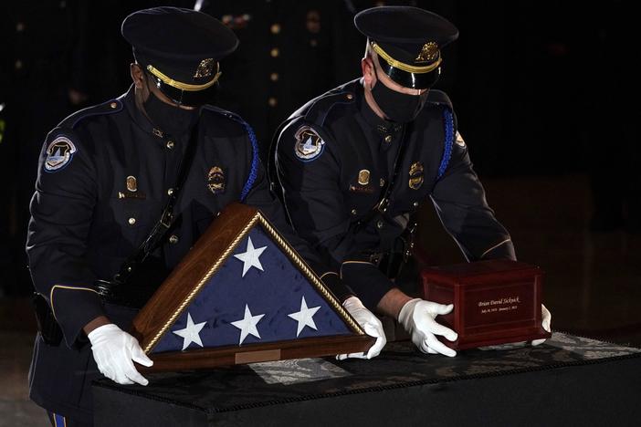 Sicknick's remains are placed next to a U.S. flag on a pedestal in the Capitol Rotunda Tuesday evening.