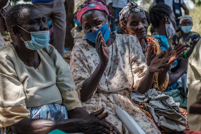 Women in Lukodi, Uganda, celebrate after hearing on a radio that the International Criminal Court in The Hague, Netherlands, found Dominic Ongwen guilty of war crimes, including a massacre in their village back in 2004.