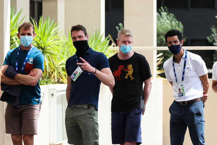 People associated with the Australian Open are seen lining up at a testing facility at the View Hotel on Thursday in Melbourne, Australia. Victoria state has reintroduced COVID-19 restrictions after a hotel quarantine worker tested positive for the coronavirus on Wednesday.