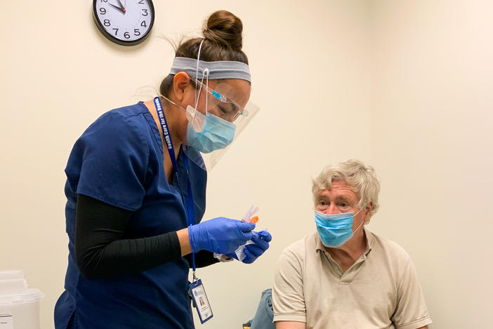 Nurse Modesta Littleman vaccinates patient Peter Sulewski in late January, on the first day of vaccinations at a clinic run by Health Care for the Homeless in Baltimore.