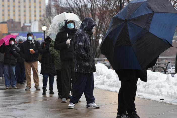 People wait in line to enter a COVID-19 vaccination site at Yankee Stadium on Friday in the Bronx borough of New York City.