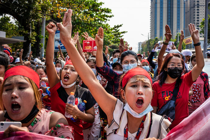 People make three-finger salutes during an anti-coup march on Saturday in Yangon, Myanmar.