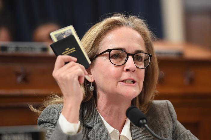 Rep. Madeleine Dean, D-Pa., holds a copy of the U.S. Constitution during a hearing related to former President Donald Trump's first impeachment in 2019.