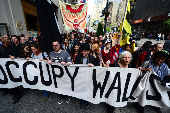 Occupy Wall Street participants march down Fifth Avenue in New York on May 1, 2012. Lingering anger over the 2008 global financial crisis has fueled several populist movements, including most recently, the battle waged by amateur investors coordinating in Reddit against hedge funds.