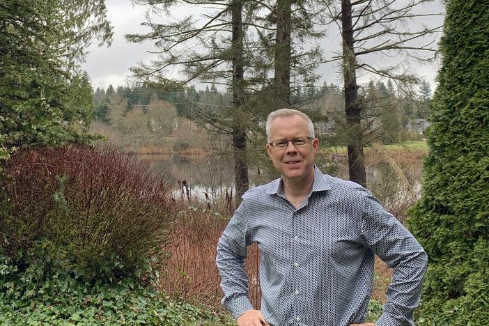 Epik CEO Rob Monster standing in the backyard of his home in Sammamish, Wash.