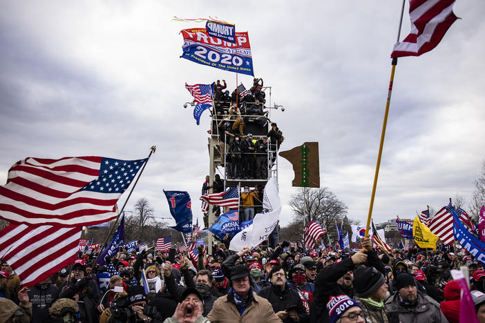 Pro-Trump supporters storm the U.S. Capitol following a rally on Jan. 6. So far, military veterans account for about 15% of those criminally charged in the Capitol riot, according to an NPR analysis.