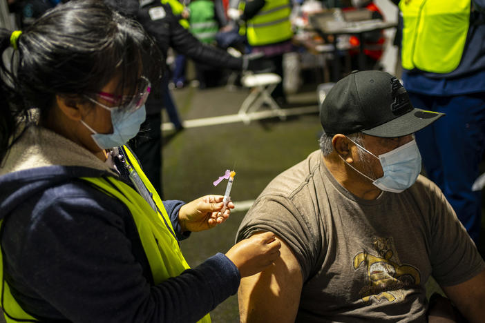 A person receives a COVID-19 shot in Federal Way, Wash., at a vaccination clinic for the Pacific Islander Community Association of Washington held on Feb. 4.