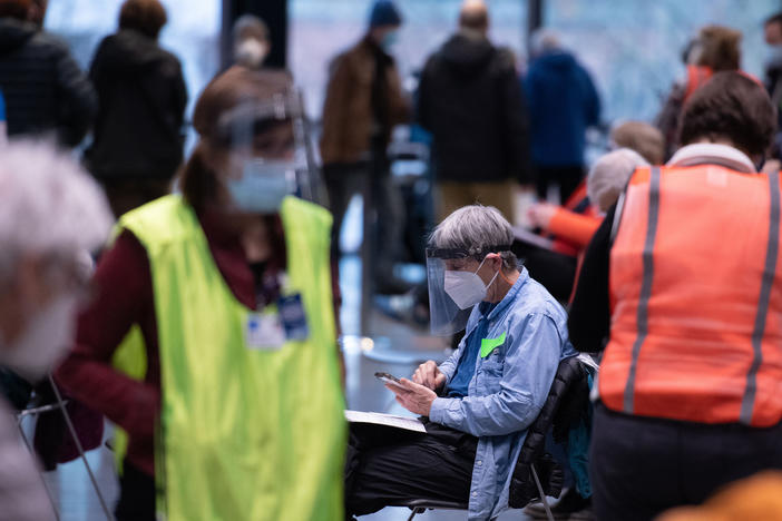 Workers and patients at a pop-up COVID-19 vaccination site near downtown Seattle in January. "The vast majority who are coming in do appear to be meeting the eligibility criteria," says Dr. Jeff Duchin, King County's public health officer.