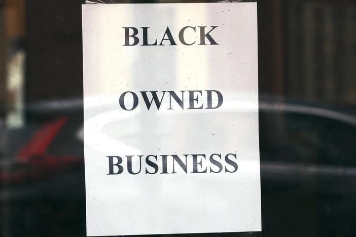 A store in Boston displays a sign noting its Black ownership on June 24, 2020. Black-owned businesses struggled to get coronavirus emergency loans last year, until community lenders stepped in to help.