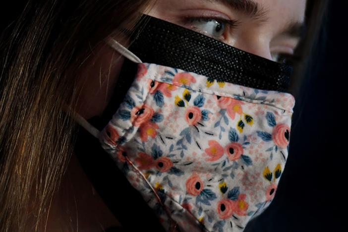 As new, more transmissible variants of the coronavirus spread, the CDC says wearing a cloth mask over a surgical mask offers increased protection against the virus.