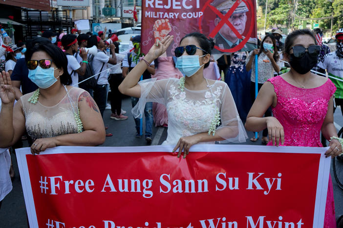 Women protest on Wednesday against the military coup that toppled the government led by Aung San Suu Kyi earlier this month. The Biden administration on Thursday announced sanctions against several of the coup leaders.