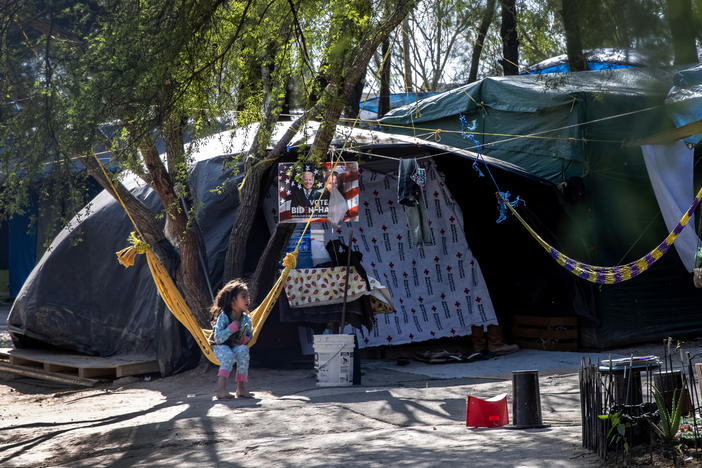 A Salvadoran girl sits inside a camp for asylum-seekers on Sunday in Matamoros, Mexico, where some 600 people who left Central America have been waiting for immigration court hearings.