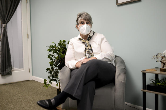 Jodee Pineau-Chaisson sits in her office in Springfield, Mass., on Jan. 12. Pineau-Chaisson, a social worker, contracted the coronavirus last May and continues to have symptoms even months after testing negative for the virus.