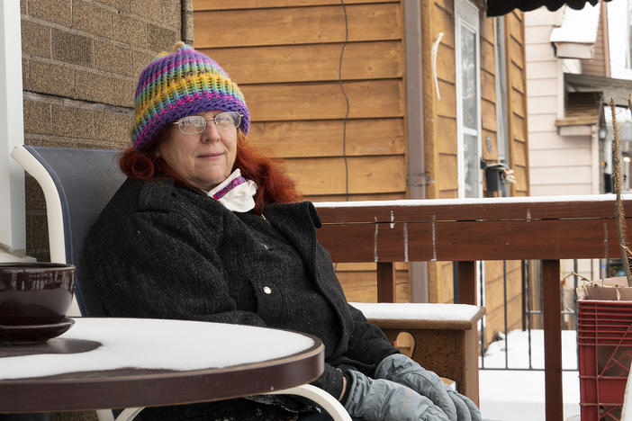 Sandra Griffin sits on her porch in St. Louis. The state of Missouri is demanding that more than 46,000 people pay back unemployment benefits they received. In December, the state told Griffin she owed nearly $8,000.