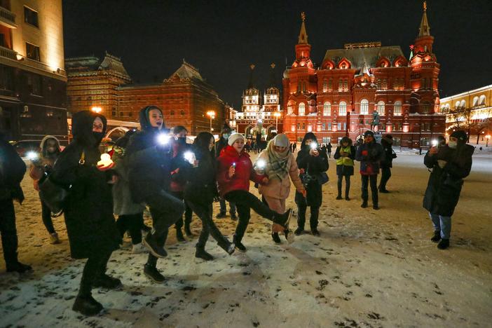 Young people dance shining their cellphone flashlights in support of jailed opposition leader Alexei Navalny and his wife Yulia Navalnaya near Red Square in Moscow on Sunday.