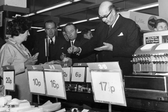 On the day of the official change to decimalized currency on Feb. 15, 1971, Lord Fiske, chairman of the Decimal Currency Board, makes a purchase at a Woolworths store in London.