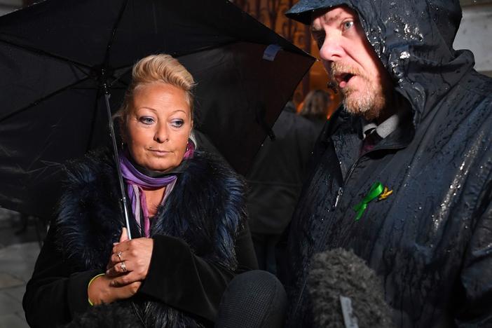 Charlotte Charles, the mother of teenage motorcyclist Harry Dunn, who was killed in a collision with an SUV driven by U.S. citizen Anne Sacoolas, stands beside her husband, Bruce Charles, as they discuss the case. Dunn's family is suing Sacoolas, who has claimed diplomatic immunity in the case.