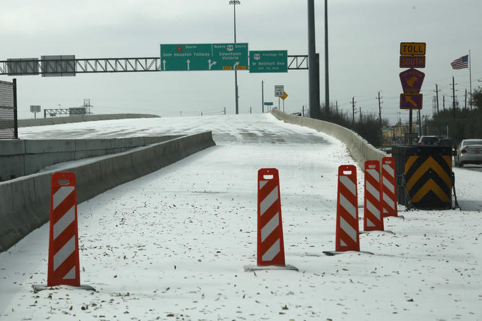 A highway on-ramp in Houston is closed due to snow and ice on Monday. Frigid temperatures, icy roads and power outages caused by a major winter storm have interfered with COVID-19 vaccine distribution in Texas and several other states.