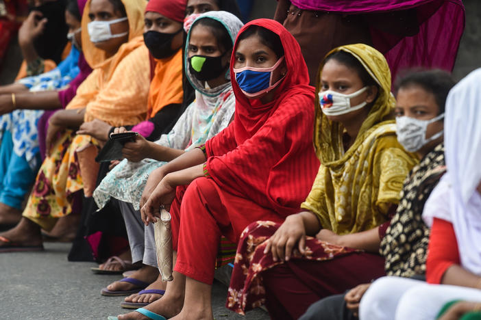 Workers from the garment sector block a road during a protest to demand payment of due wages, in Dhaka, Bangladesh, in April 2020. They claimed that factories had not paid them after retailers and brands cancelled orders due to worldwide lockdown measures.