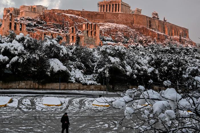 The setting sun illuminates the ancient Acropolis in Athens, Greece, after a rare heavy snowfall in the city on Tuesday.