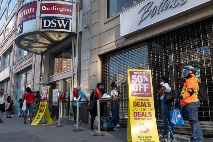 Shoppers line up near sale signs at a Burlington store in New York in June.