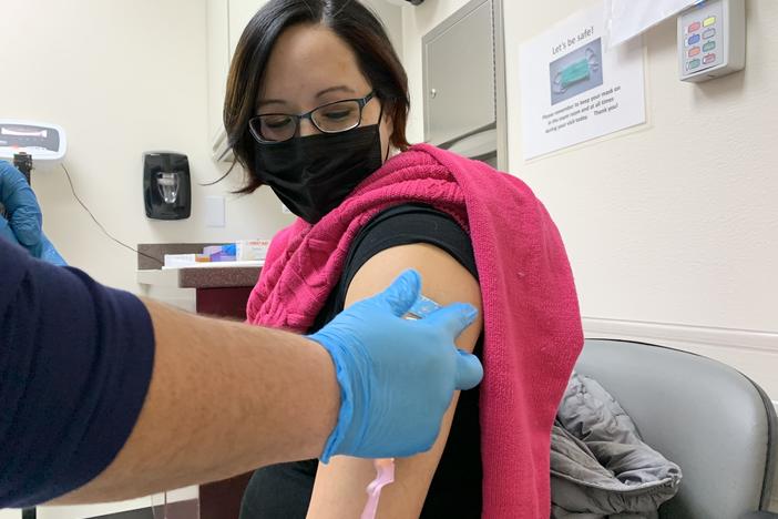 Amanda Bordeaux, 36, gets her second dose of the Pfizer vaccine during a weekly mass vaccination clinic at the Rosebud hospital in South Dakota.